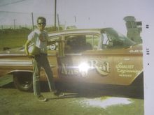 My dad in the cool down area at the original Irwindale drag strip thats now Miller brewery. If you google it the area tge track was is still there. My dad had a box of trophies from this car. I kept the one from the day of this photo. Its on my shelf.