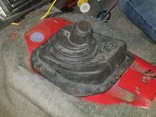 Lining up the shifter boot so the inner corner lines up with the pilot hole we marked and drilled earlier