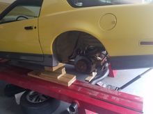 Back end WAAAY up in the air.  Braced with wood blocks on both sides, plus my floor jack providing support under the torque tube.