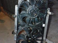 Here are the fans with the custom mounts bolted onto the shroud. I made the mounts out of some angle-steel and flat-stock. It bolts on using the factory mounting holes from the old fan.