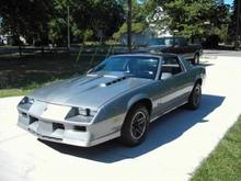 Camaro with stock wheels before hood work and black decals