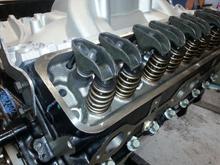 My springs after the heads got back from the machine shop. Had to machine the valve guide boss to fit my springs and installed screw in studs.