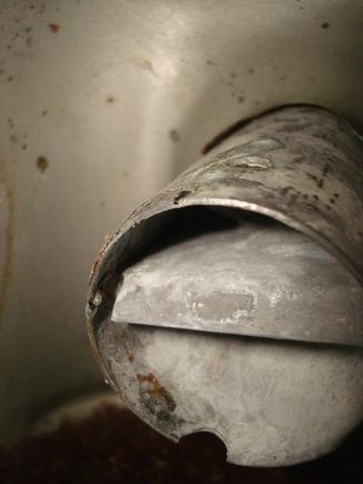 Tank has a baffle wall just a few inches from the end of the fill tube.
