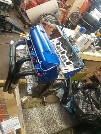 Red head bolts give it a nice touch 😉

Heads are torqued  ✔
Headders slotted and test fitted ✔
Water pump and timing cover painted last night gona put them on today..

Just missing the oil pump pick up tube... nobody can get it locally, looks like i gotta get it from summit.

Also which flywheel should i be using the 3.4 or 2.8? The tranny is a T5 from my 86 2.8 bird. 
I remeber reading that they were balanced diffrently.