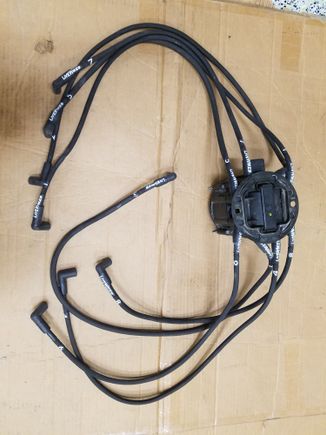 Wires almost new. Cost over hundred new, have high temp covering along all wire and heatshrunk boots. These are made to run underneath headers and not over valve covers. I dont have a pic of distributor yet.