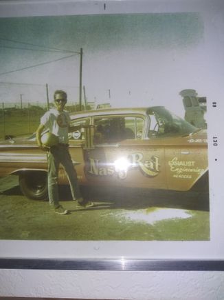 My dad in the cool down area at the original Irwindale drag strip thats now Miller brewery. If you google it the area tge track was is still there. My dad had a box of trophies from this car. I kept the one from the day of this photo. Its on my shelf.