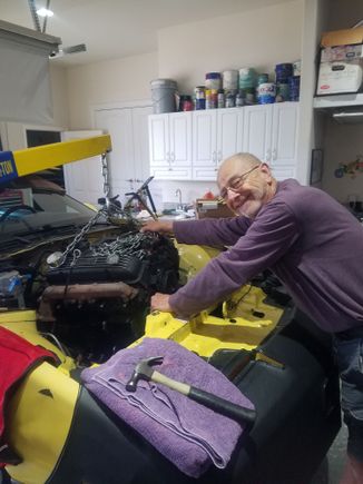 Father lending a hand to keep the engine from crashing into the firewall.  I'd wanted to install my load leveler, but there wasn't enough room along the back side of the head to install the bracket.
