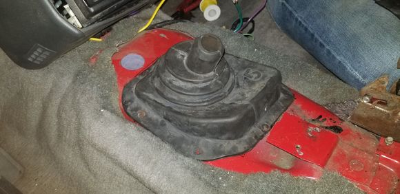Lining up the shifter boot so the inner corner lines up with the pilot hole we marked and drilled earlier