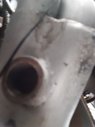 It's hard to see due to lack of light. There is a big "wall" of metal inside the hole. It basically blocks an 02 sensor from being screwed in.

This is on the driver's y-pipe near the header.