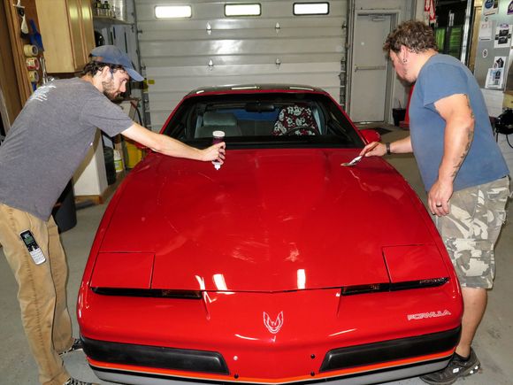 Applying Slide on slime to car hood.