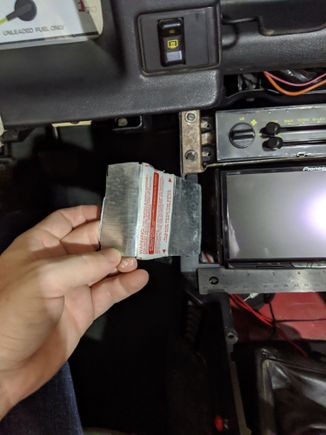 I started with some really thing aluminum, this was originally from a cheap wall socket box I didn't need.  Use thin metal so you can bend, and cut easily.  Use a ruler to make sure the radio is centered, then bend the metal so you have more than enough space to reach the center console holes.