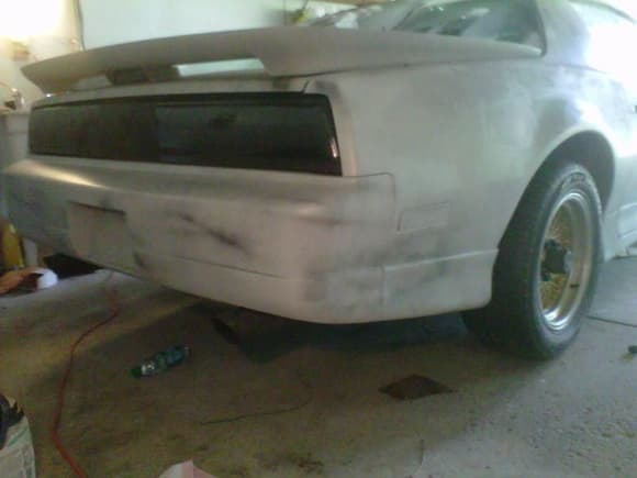 fiberglass spoiler not bolted on yet, tails tinted, filler still off and in rough primer