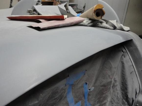 repaired a rust hole by welding in patch, some grinding, bondo and primer sealer.