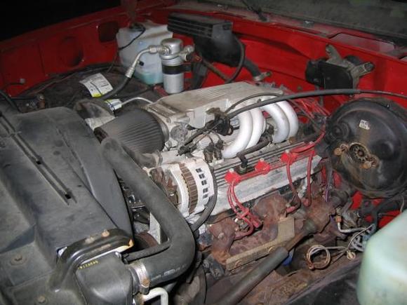 The dormant beast. The block is original to the truck, but everything else is different. From my uncle who helped build the engine I know it was bored over .30 to make it a 383, has Eagle Specialty Products forged stroker rotating assembly (H-beam rods, flat pistons), hydraulic roller lifters, moly push rods, trick flow aulm. heads, roller rockers, comp cams camshaft (.5-.51 lift 288 dur.), stiffer springs, high flow oil pump, edelbrock performer seires valve covers, 36lb injectors, and more I just don't know about. It powers a built up 700R4 trans to a 10 bolt chevy rear-end. It used to have a B&amp;M 144 Blower on it, but my dad must have put the TPI back on.