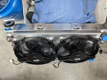 Here is the finished radiator shroud, radiator and 2 massive 11" spal fans that are completely sealed to the rad with more rubber foam. Those things are rated for 1300 CFM each at 0 in/hg, and have the amperage to move some serious air. This thing better not overheat, because I have probably 20 hours in just this damn rad and shroud alone.