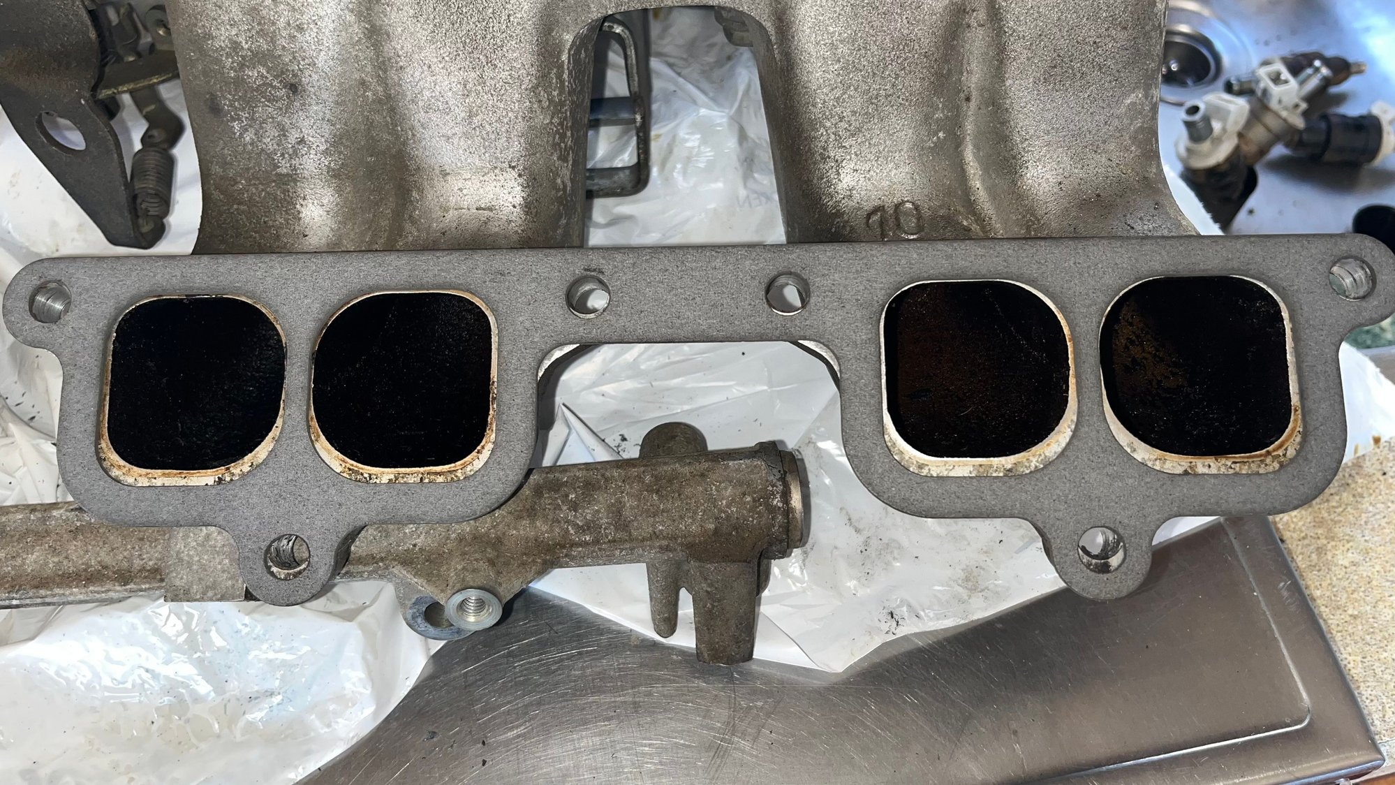 Plenum to intake manifold, top bolt holes aligned and bottom not