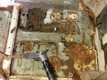 drivers side floor nearly done the last bit fought tooth an nail to stay stuck on the jack sits lower right the seat belt bolts to the shiny hole lower right