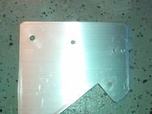 I used a 6"x6"x1/4 inch piece of aluminum stock cut to this shape. I then drilled the appropriate holes to mount the CB, Mic hanger to this plate. I then measured the distance between the bolts on the right side of the gauges and drilled two holes  for mounting this bracket.