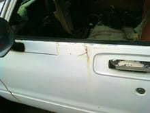 drivers door with a major rust out the panel there is glued an rivited on the bondo is cracked showing it