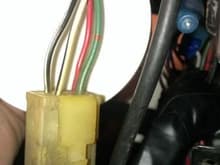 Connector, 4-socket, behind radio/ashtray console: wires are Black/with White line along length of wire, White/with Black line along length of wire, Green/with Red intermittent marks around the wire along the length of wire, Red/with Blue line along the length of wire; what is it?
