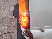 Passenger side with tail light bleeding through into white reverse reflector