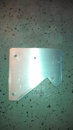 I used a 6"x6"x1/4 inch piece of aluminum stock cut to this shape. I then drilled the appropriate holes to mount the CB, Mic hanger to this plate. I then measured the distance between the bolts on the right side of the gauges and drilled two holes  for mounting this bracket.