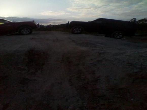 my buddy and i on a hill he later slid down the side into some rocks ruining his expensive factory steps...now he has more ground clearance once his parents give him his truck back