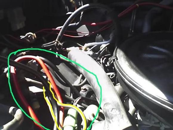 I have marked one of the hoses on the passenger side fender well yellow...it is attatched to a small metal something and the other end of the same hose loops around and is attatched basically to the same metal thingy. Everything that is circled by the green is what we are unsure of. We cannot find anyone w/ a Yota that has this set up. The motor is supposively rebuilt. DOes anyone happen to have any advice??