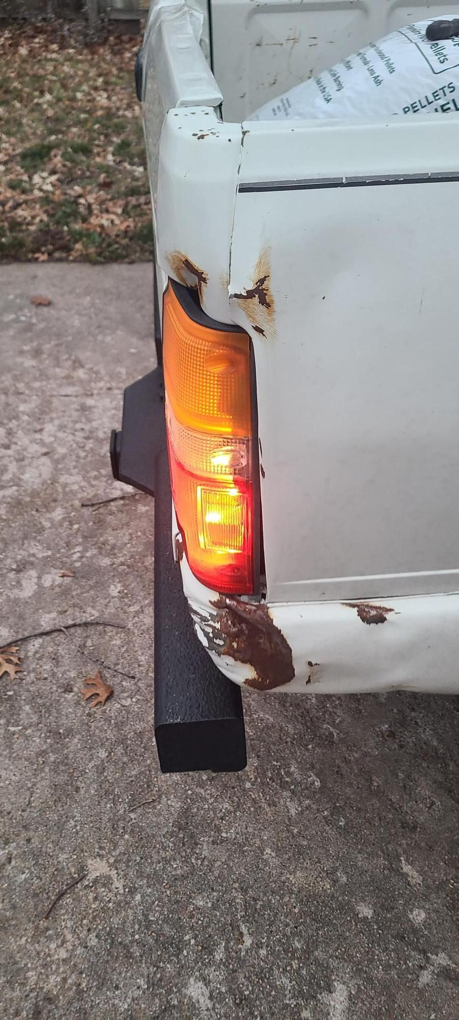 Passenger side with tail light bleeding through into white reverse reflector